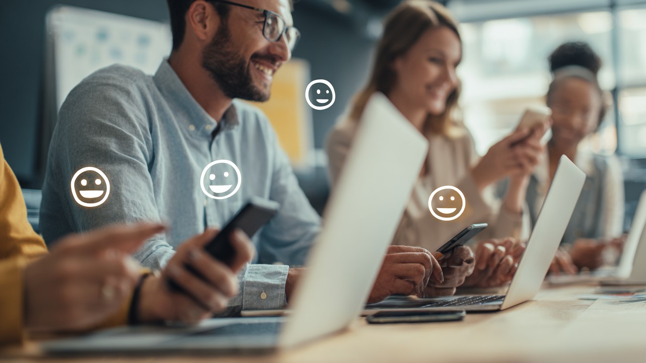 Diverse professionals providing user feedback on digital devices in a modern office, emphasizing user experience and satisfaction.