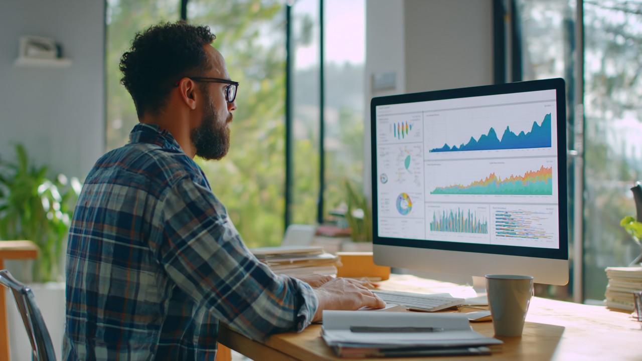 Modern office with a digital marketing analyst analyzing website performance data on a large screen, natural light, clean workspace.