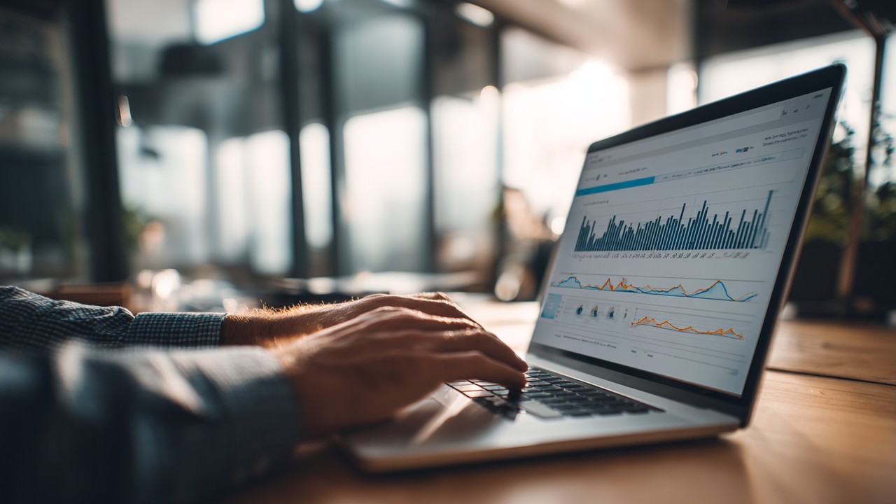 Close-up of a web developer analyzing website performance metrics on a laptop, with WooCommerce product search results and performance graphs in a modern office.