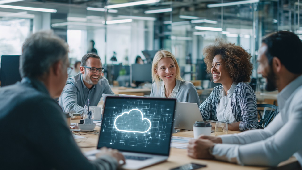 Modern diverse professionals collaborating around a laptop with cloud computing and serverless architecture diagrams in a bright, clean office.